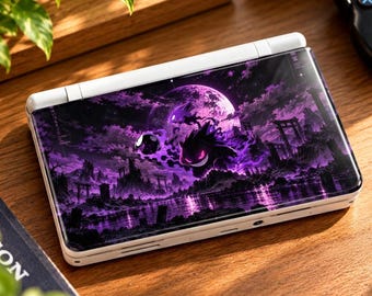 Könnte beinhalten: Eine weiße tragbare Spielkonsole mit einer individuellen Abdeckung, die eine violette Grafikillustration eines Gengar-Charakters, einen großen Mond und eine dunkle Landschaft mit Torii-Toren zeigt.