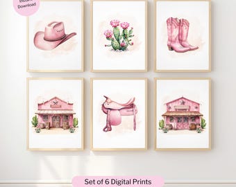 May include: Set of six framed digital prints with a watercolor theme. The prints feature a pink cowboy hat, cactus with pink flowers, pink cowboy boots, a pink building, a pink saddle, and another pink building. The text "Set of 6 Digital Prints" is also visible.