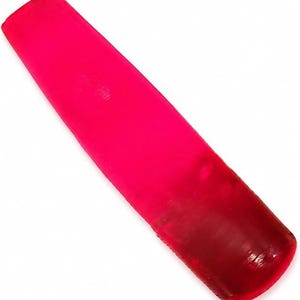 May include: A translucent, vibrant hot pink shoehorn with a smooth, elongated, and slightly curved design. The object features a rounded, scoop-shaped end for assisting with footwear and a tapered handle, showcasing a uniform, glossy finish.