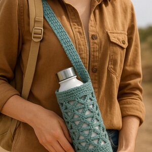 May include: A teal crocheted water bottle holder with a matching strap. The holder has a geometric openwork design and is holding a white stainless steel water bottle with a silver lid. The person is wearing a brown button-up shirt and a tan backpack strap.