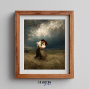 May include: A framed print of a romantic painting. The artwork shows a couple embracing in a field of tall grass under a dramatic, cloudy sky. The frame is made of wood. The text "THE STATIC INK Studio" is at the bottom.