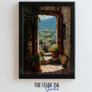 May include: Framed art print of a scenic Italian landscape. The artwork depicts an open doorway with shutters, revealing a vibrant valley and distant mountains. Colorful flowers in terracotta pots adorn the steps. The Static Ink Studio logo is at the bottom.