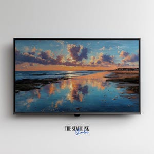 May include: A framed landscape painting of a beach scene at sunset. The artwork features a vibrant sky with orange and purple clouds reflected in the calm water. The text "THE STATIC INK Studio" is at the bottom.