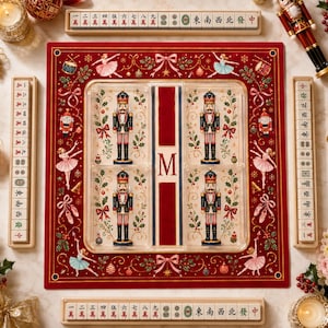 May include: A mahjong set featuring a red game mat decorated with nutcracker and ballerina illustrations, four nutcracker figurines in a clear tray with a central letter M, and four wooden racks holding mahjong tiles with Chinese characters.