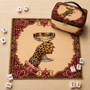 May include: A square mahjong mat and a matching rectangular carrying case, both featuring a beige centre with a leopard print paw holding a champagne glass, surrounded by a dark red floral border with gold accents and scattered mahjong tiles.