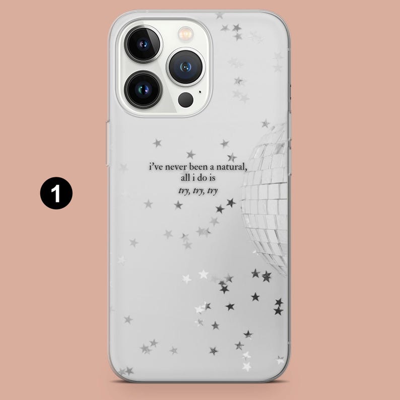 May include: Clear phone case with a white background, featuring a disco ball and star pattern. The case has the text "i've never been a natural, all i do is try, try, try". The phone case has a camera cutout.