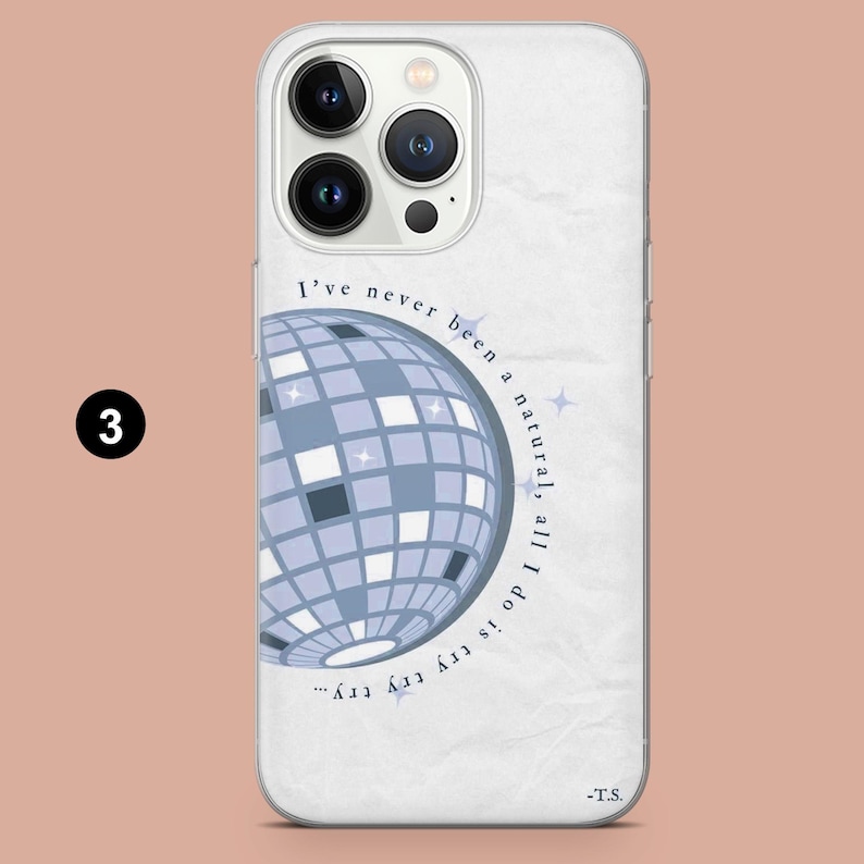 May include: A white phone case featuring a blue disco ball design with the text "I've never been a natural, all I do is try try try..." and the initials "-T.S." The case has a clear border and a light pink background.