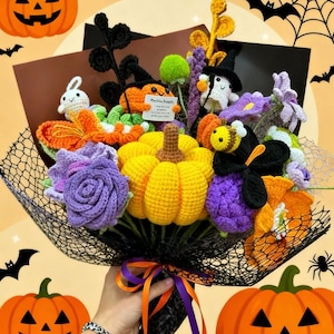 May include: A handmade crochet Halloween bouquet featuring a large yellow pumpkin, purple and orange flowers, and various Halloween-themed figures like a ghost, bee, and bunny. The bouquet is wrapped in black netting and tied with orange and purple ribbons.