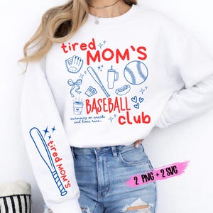 May include: White sweatshirt with the text "tired MOM'S BASEBALL club" in red and blue. The design includes baseball-themed illustrations like a glove, bat, ball, and hot dog. The sleeve features a baseball bat and the words "tired MOM'S".