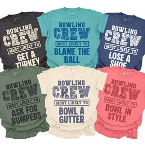 May include: Six short-sleeved t-shirts in different colours, each bearing the text "BOWLING CREW" and a humorous phrase such as "MOST LIKELY TO BLAME THE BALL." These are casual wear items.