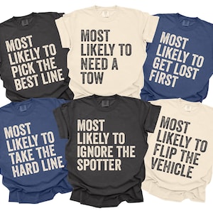 May include: Six short-sleeved t-shirts in various colours, including black, navy, and cream. Each shirt features the phrase "MOST LIKELY TO" followed by a different humorous statement in bold, white text, such as "PICK THE BEST LINE."
