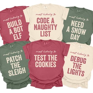 May include: Six short-sleeved t-shirts in various colors, each with a different holiday-themed phrase in a distressed font. Phrases include "Build a Bot Elf," "Code a Naughty List," and "Need a Snow Day."