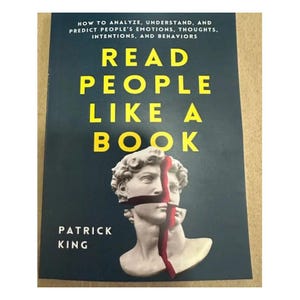 May include: A book cover with the title "READ PEOPLE LIKE A BOOK" in large yellow letters. The cover features a fragmented statue head with a red line through it, set against a dark blue background. The author's name, Patrick King, is at the bottom.