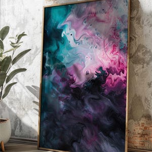 May include: Abstract art print in a wooden frame. The artwork features a swirling mix of colors, including teal, pink, purple, and black. The fluid design creates a dynamic and visually engaging piece, suitable for modern home decor.