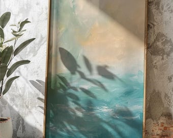 May include: Abstract art print in a wooden frame. The artwork features a blend of teal, blue, and beige hues, evoking a sense of the ocean and sky. The frame is a light brown color. The image is leaning against a textured wall.