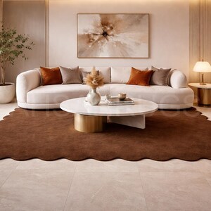 Luxury solid brown area rug with soft wavy edges placed in a modern minimalist living space, contemporary carpet on marble floor with wooden table and neutral walls, elegant modern rug for living room bedroom and hallway décor