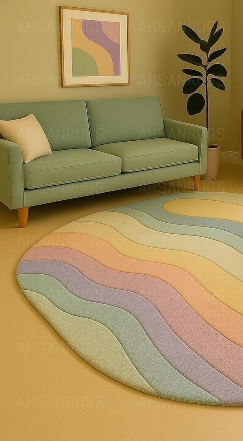 Round pastel area rug with abstract wavy pattern in soft hues of lavender, blush, yellow, green, and blue. Handmade wool rug styled in a modern boho living room with light green sofa, wooden cabinet, and neutral decor.