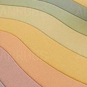 Round pastel area rug with abstract wavy pattern in soft hues of lavender, blush, yellow, green, and blue. Handmade wool rug styled in a modern boho living room with light green sofa, wooden cabinet, and neutral decor.