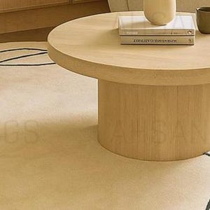 Modern irregular shaped cream rug with abstract wavy edge design, minimalist black and orange line art pattern, contemporary carpet for living room or bedroom décor.