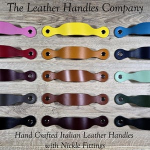 May include: A collection of colorful leather handles with nickel fittings. The handles are in various colors, including pink, yellow, blue, burgundy, brown, black, and green. The text "The Leather Handles Company" and "Hand Crafted Italian Leather Handles with Nickle Fittings" are visible.