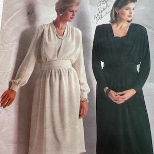 May include: Vintage Butterick sewing pattern featuring two women modeling dresses. One dress is cream-colored with long sleeves and a cinched waist. The other is a black dress with a square neckline. The pattern size is 12.