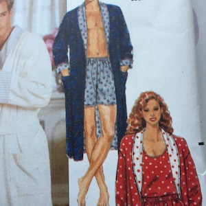 May include: A sewing pattern featuring two robes. One robe is blue with a paisley pattern and the other is red with white polka dots. The pattern number is 031664091653.