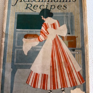 May include: Vintage cookbook cover featuring the text "Fleischmann's Recipes." The illustration depicts a woman in a red and white striped dress and apron, removing bread from an oven. The background has a blue and yellow striped pattern.