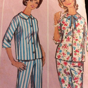 May include: Two women's pajama sets, one with blue and white stripes and the other with a floral print. Both sets feature a button-up top and pants.