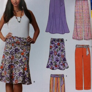 May include: A sewing pattern for a skirt and pants. The pattern includes four different styles: a purple skirt with a belt, a floral skirt with a belt, a striped skirt with a belt, and a pair of orange pants with a belt.