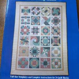 May include: A book titled "Making an Old-Fashioned Patchwork Sampler Quilt on the Sewing Machine" by Andrea L. Shedletsky. The cover features a colorful patchwork quilt design with various geometric patterns in shades of blue, green, red, and beige.
