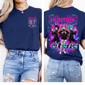 May include: Navy blue t-shirt with a graphic on the front and back. The front graphic includes the text "HUNTRIX", "67", and "SIX SEVEN". The back graphic features three anime-style characters and the text "HUNTRIX" and "SIX SEVEN".