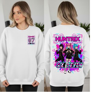 May include: White sweatshirt with a graphic on the front and back. The front features a small design with the text "HUNTRIX 67 SIX SEVEN". The back has a larger design with the text "HUNTRIX SIX SEVEN" and a colorful anime-style illustration.