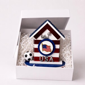 USA soccer mini house placed inside white gift box with protective filler for safe packaging