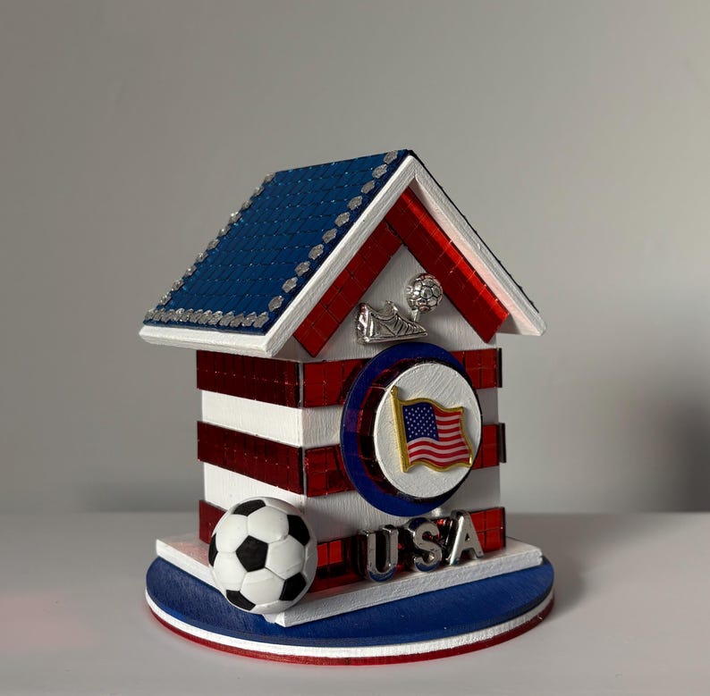 Decorative USA soccer house with American flag emblem, red mirrored accents, and blue tiled roof