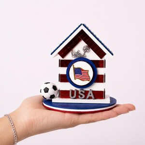 Small USA soccer house resting in hand showing size and detailed craftsmanship
