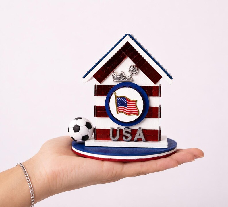 Small USA soccer house resting in hand showing size and detailed craftsmanship