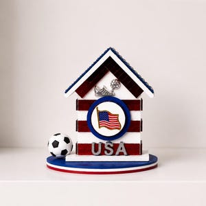 USA soccer decorative house displayed on clean white shelf with minimal background