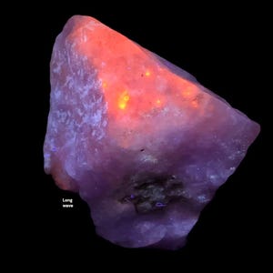 May include: A large, irregularly shaped rock with a gradient of colors. The top portion glows with a vibrant orange and yellow, transitioning to a deep purple at the base. The text "Long wave" is visible.