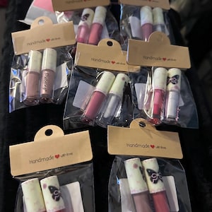 May include: A handmade wooden sign with the text "Welcome" in a playful font. The sign features a distressed white background and a dark brown frame, perfect for a front door or entryway. The sign measures approximately 12 inches wide and 6 inches tall.