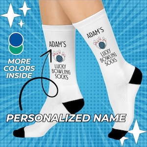 May include: White socks with black heels and toes, featuring a bowling design and the text "ADAM'S LUCKY BOWLING SOCKS." The socks have a personalized name and are decorated with bowling pins and a bowling ball. The background is blue.