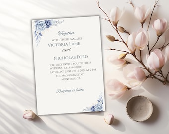 May include: A wedding invitation with floral accents in shades of blue. The invitation text reads "Together with their families Victoria Lane and Nicholas Ford" and announces a wedding celebration on June 27th, 2026, at 2 PM in Monterey, CA.