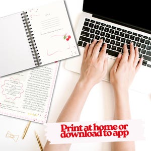 May include: A white spiral-bound notebook with cherry illustrations and lined pages is open on a white surface. A laptop with hands typing on the keyboard is in the background. The text "Print at home or download to app" is at the bottom.