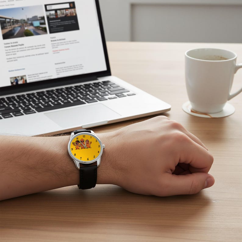 May include: A wristwatch with a silver-tone case and a black leather strap. The watch face is bright yellow and features a graphic illustration of three cartoon potato characters wearing sunglasses and hats, with black numerals marking the hours.