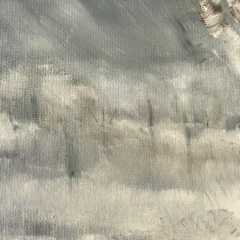 May include: A close-up of a textured canvas painting with a light gray background and a hazy, white foreground. The painting depicts a landscape with a few trees in the distance.