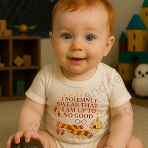 May include: A baby wearing a cream-colored onesie with the text "I Solemnly Swear That I Am Up To No Good" and a Harry Potter-themed graphic. The baby is holding a Harry Potter figurine. The background includes a castle painting and wooden toys.