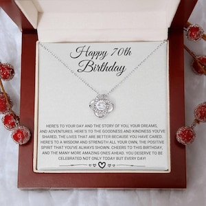 May include: A silver necklace with a sparkling pendant, presented in a gift box. The box contains a card with the text "Happy 70th Birthday" and a heartfelt message. The necklace is a thoughtful gift for a milestone celebration.
