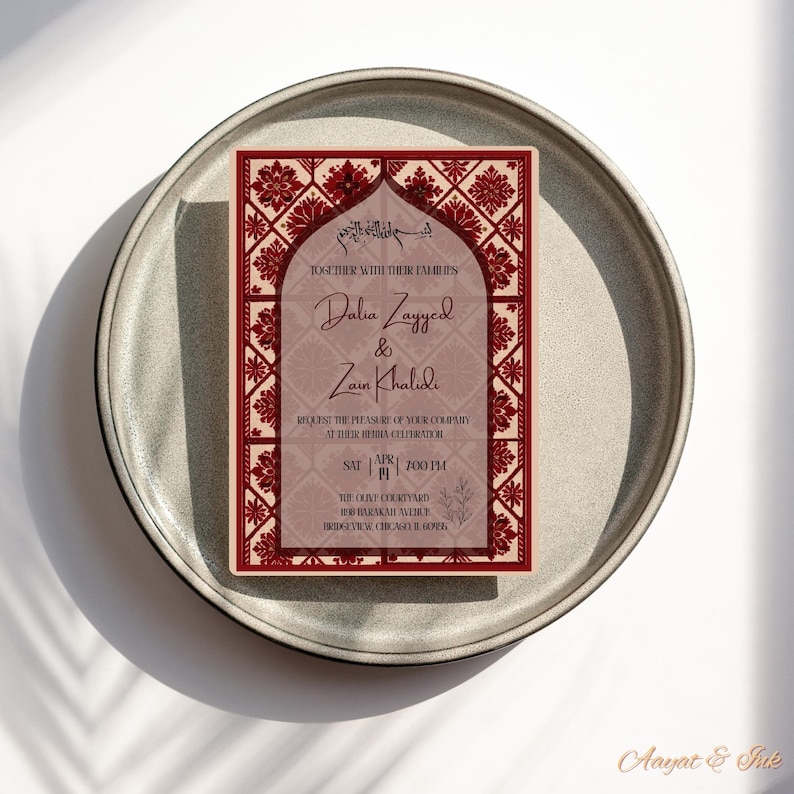 May include: A rectangular invitation card with a burgundy and cream color scheme, featuring floral and geometric patterns. The card includes names, event details, and the phrase "Together with their families."