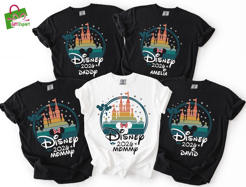May include: Five black and white t-shirts with a Disney castle design. The shirts have the text "Disney 2026" and names "Daddy", "Amelia", "Mommy", and "David". The design includes a castle, Mickey Mouse ears, and a bow.