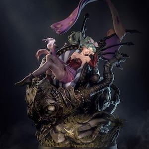May include: A detailed figurine of a woman with green hair, wearing a red and purple dress, reclining on a mechanical structure. The sculpture features intricate details, with a dark color palette and a dramatic pose. The base of the sculpture has the logo "NYMPHA3D".