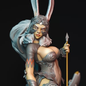 May include: A detailed figurine of a warrior woman with long white hair and rabbit ears, wearing silver armor and a helmet. She holds a spear and has a determined expression. The figure has a stylized design with intricate details and a fantasy theme.